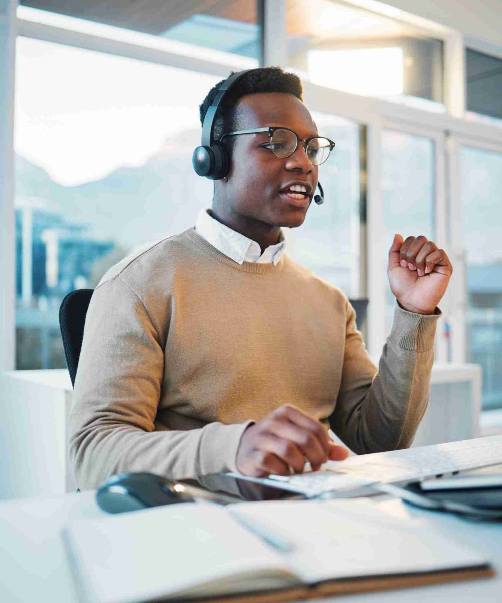 Call center, black man and consulting at computer for telemarketing, customer service and IT suppor.