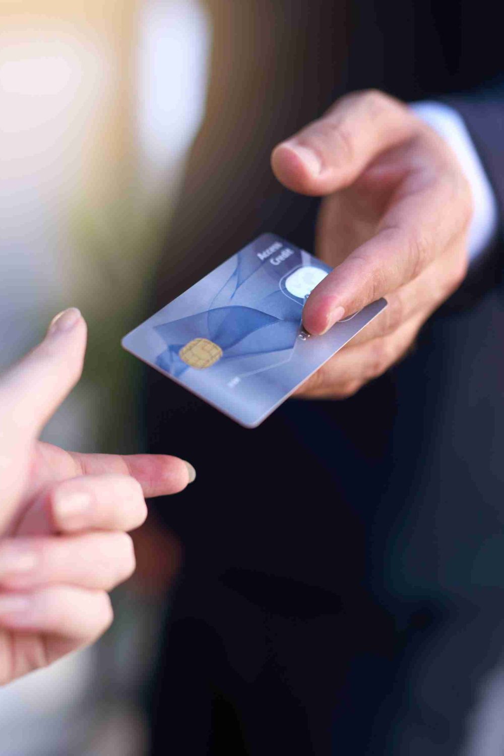 Paying by card. Cropped shot of a businessman holding out a credit card as payment